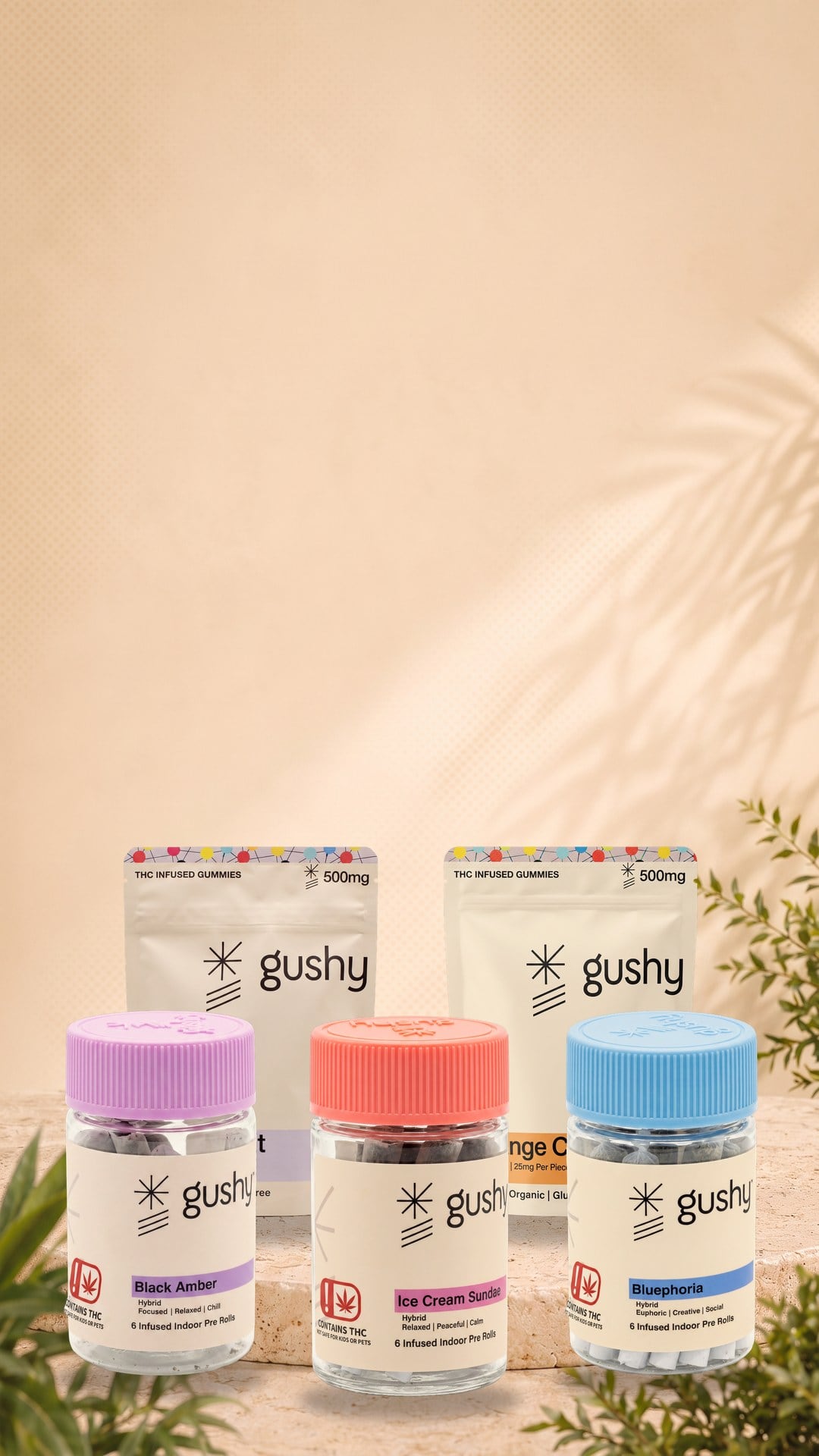 The Gushy line on a round travertine plinth: pre-roll jars in front of live resin gummy pouches, with palm leaves in the corners
