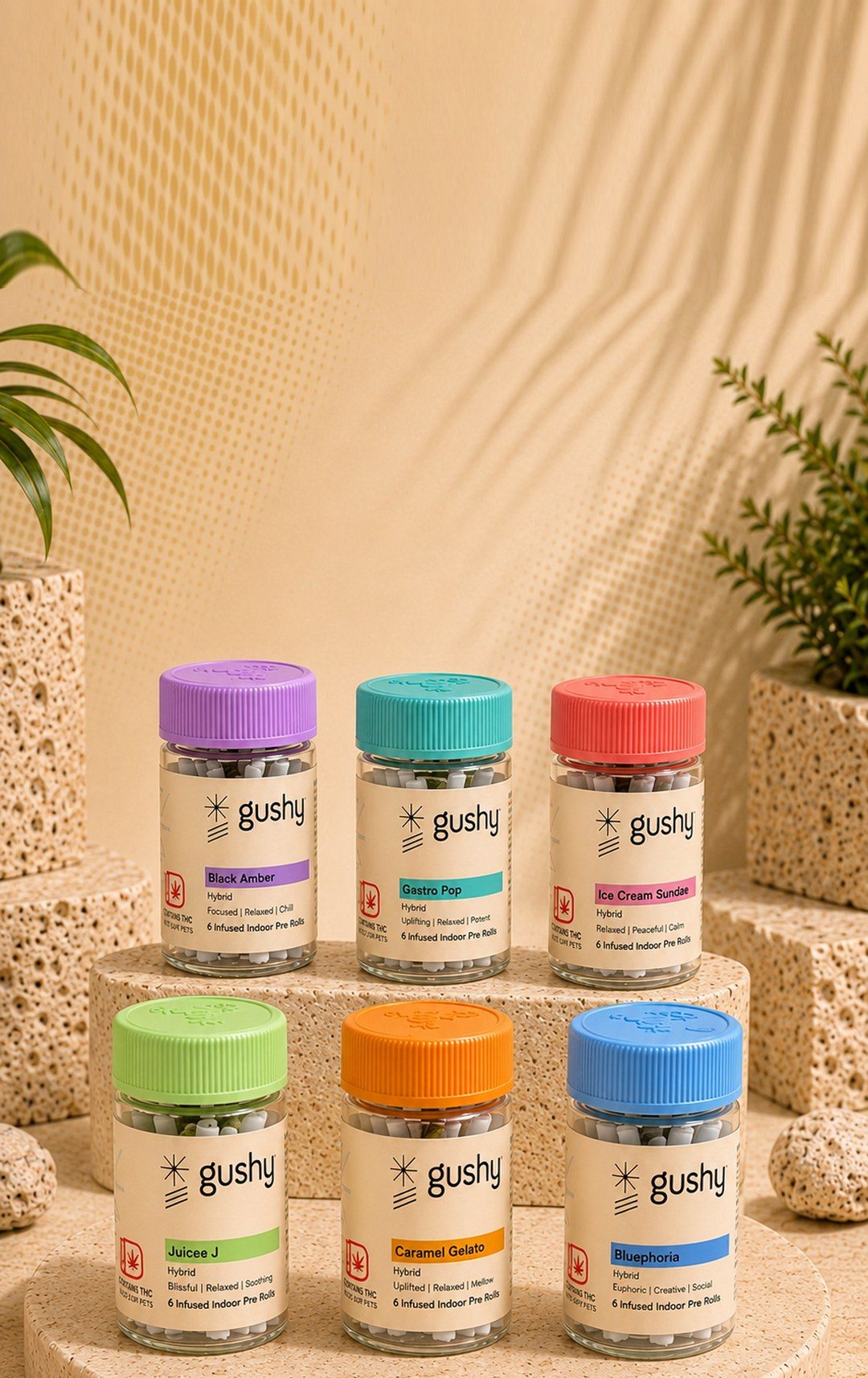 The six Gushy infused pre-roll jars arranged on a round stone platform
