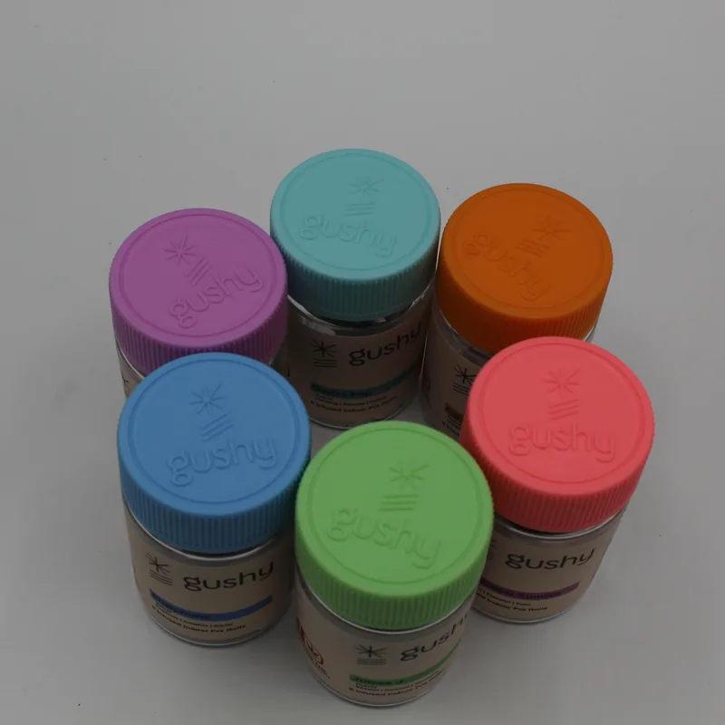 Top view of the six color-coded child-resistant Gushy jar lids
