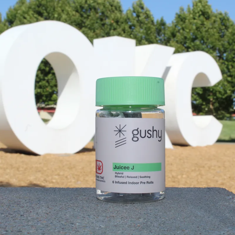 A Juicee J jar in front of the big white OKC letters in Oklahoma City