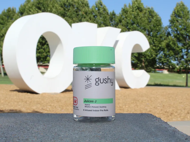 A Juicee J jar in front of the big white OKC letters in Oklahoma City