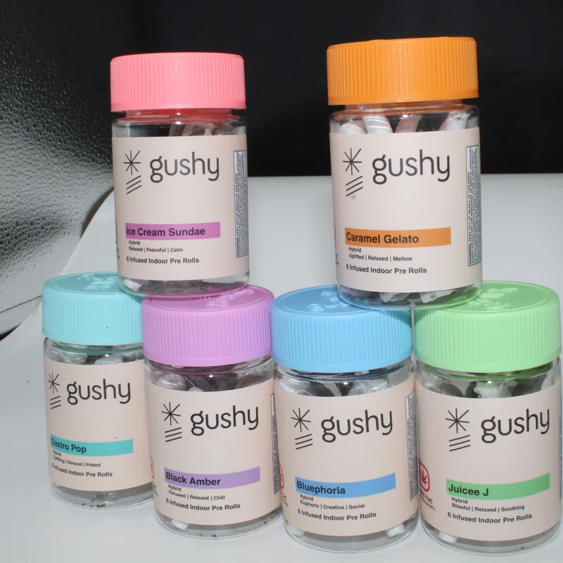The six Gushy pre-roll jars stacked two over four, every lid a different color